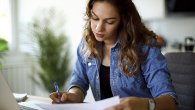 A woman reviewing her student loan repayment information.