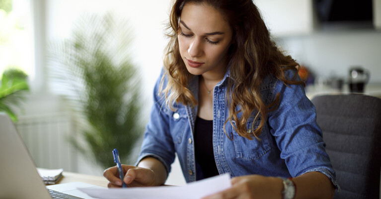 A woman reviewing her student loan repayment information.