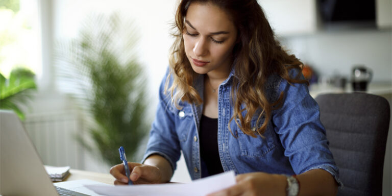 A woman reviewing her student loan repayment information.