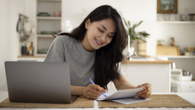 A woman signing documents.