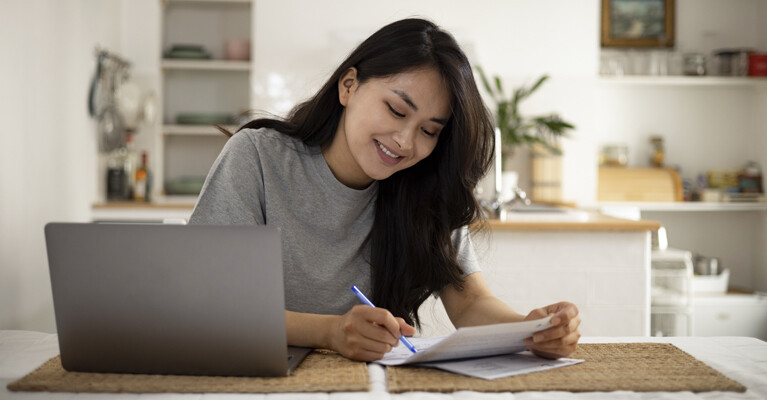 A woman signing documents.