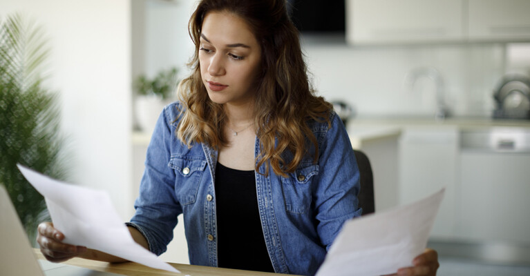 A woman holding papers.