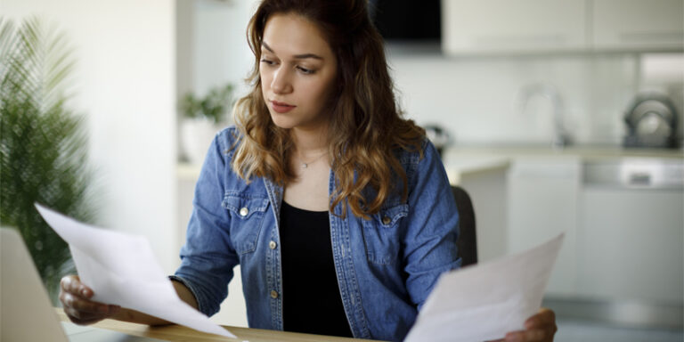 A woman holding papers.