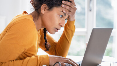 Woman looking intently at a laptop computer.