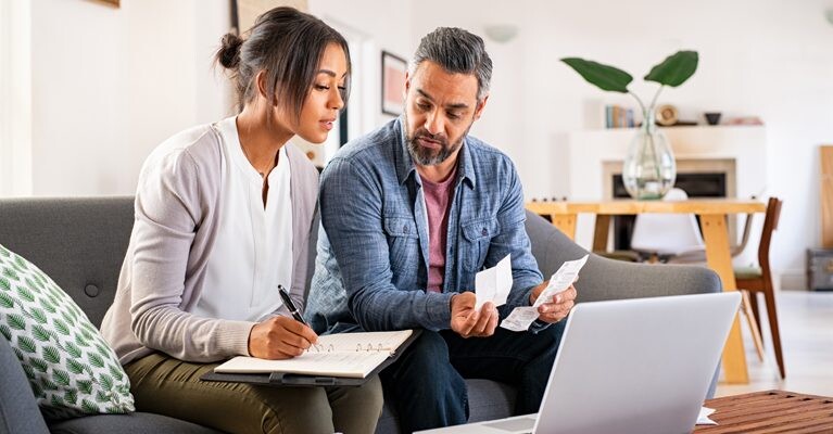 Man and woman paying bills.