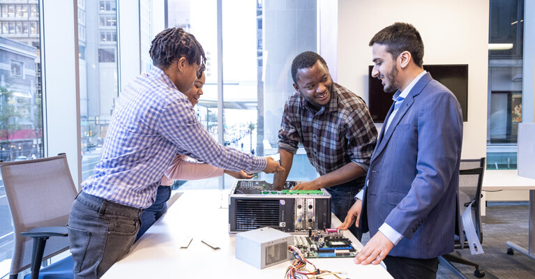 Tech Impact students working on a computer.