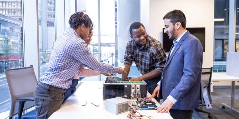 Tech Impact students working on a computer.