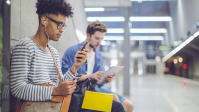 Two commuters waiting in a subway station.