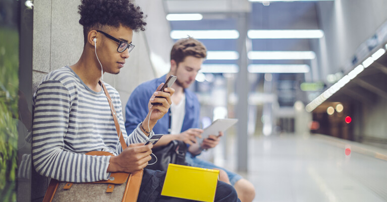 Two commuters waiting in a subway station.