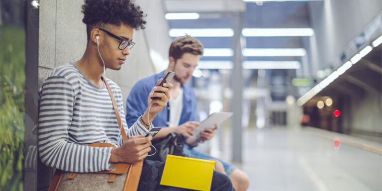 Two commuters waiting in a subway station.
