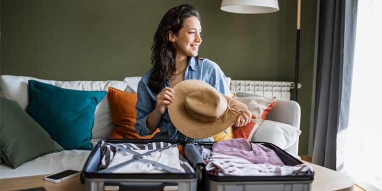 A woman packing a suitcase for vacation.