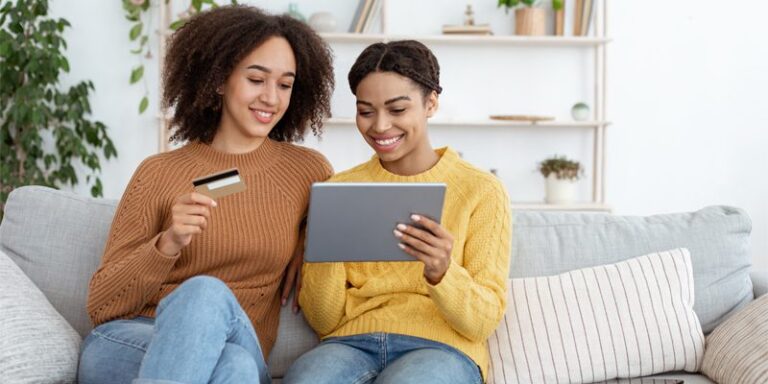 Two women making an online purchase using a credit card.