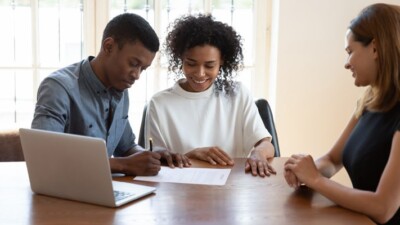 Man and woman signing documents.