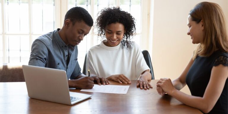 Man and woman signing documents.