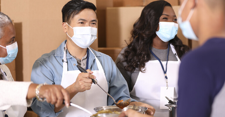 Volunteers serving food.