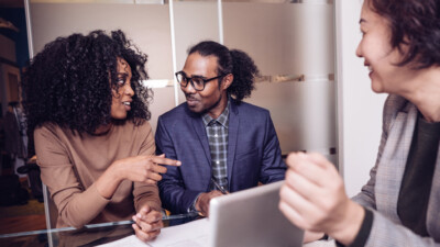 A couple talking with a businessperson.