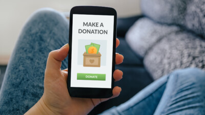 A phone screen displaying a graphic that says "Make a Donation" and a button that says "Donate."