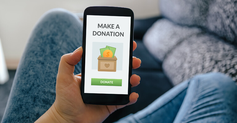 A phone screen displaying a graphic that says "Make a Donation" and a button that says "Donate."