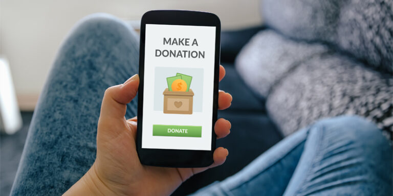 A phone screen displaying a graphic that says "Make a Donation" and a button that says "Donate."