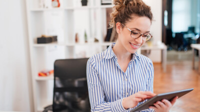 A woman using a tablet.