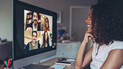 Woman videochatting with others on computer.