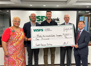 WSFS Associates present a giant check for $1,000 to Make the World Better Foundation.