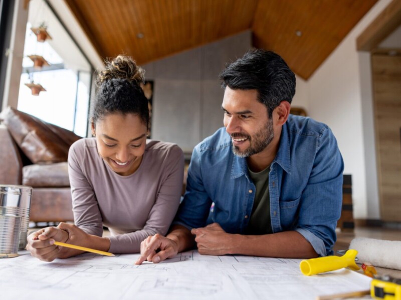 Man and woman looking at construction plans.