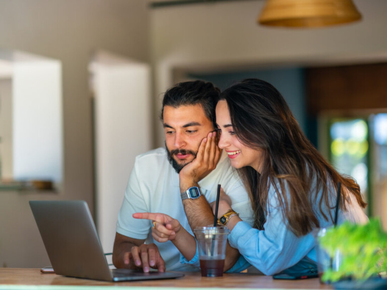 Man and woman using laptop.