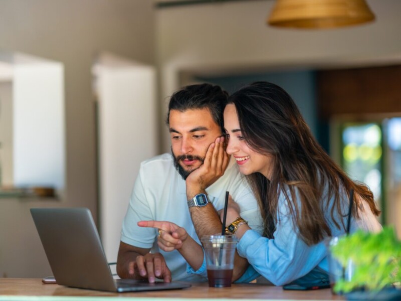 Man and woman using laptop.