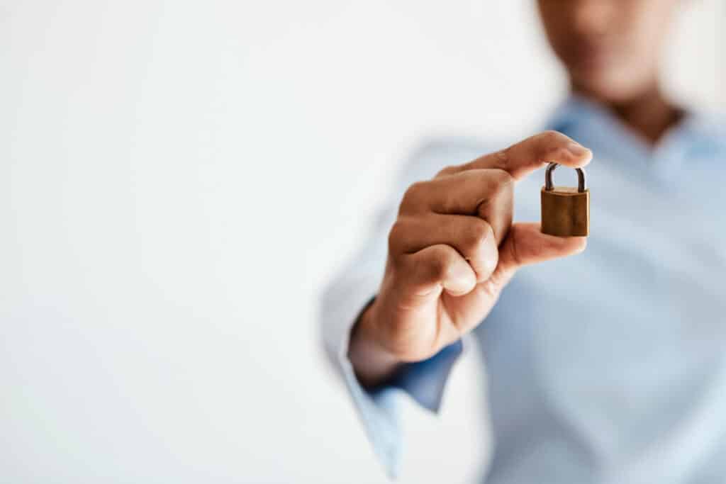 Man holding padlock to signify fraud protection.