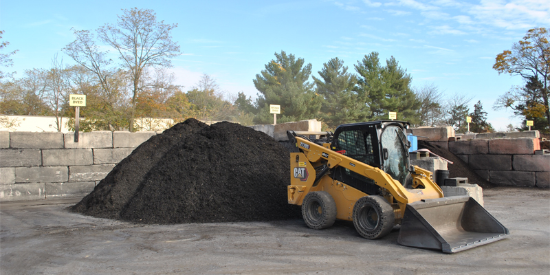 Construction equipment moving mulch for Mulch & More.