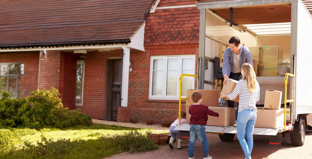 Family unpacking moving truck