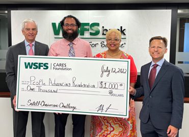 WSFS Associates present a giant check for $1,000 to PAR-Recycle Works.