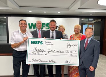 WSFS Associates present a giant check for $1,000 to Philadelphia Youth Basketball (PYB).