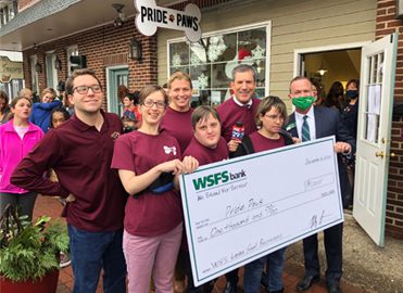 Employees from Pride Paws holding a giant check for $1,000 along with a WSFS Associate and FOX29’s Bob Kelly.