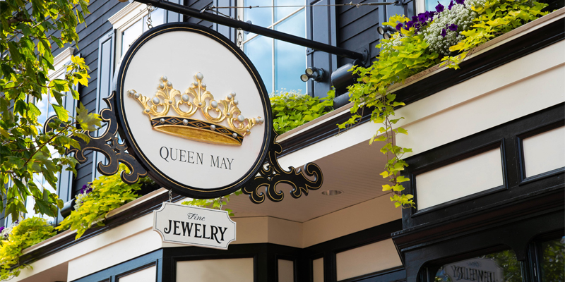 Queen May, close up of storefront sign