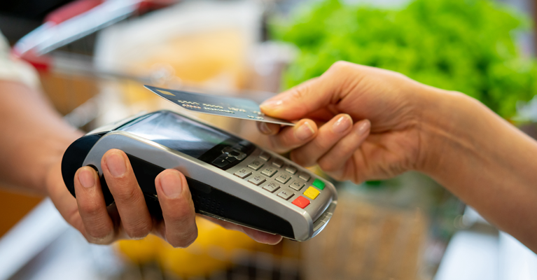 A credit card transaction being made with a handheld point-of-sale system.