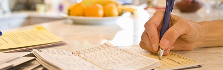 A person writing a check.