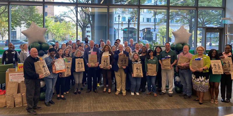 Sunday Breakfast Mission employees and WSFS Associates celebrate the kickoff of their annual Food Drive.