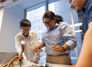 Tech Impact students working on a computer.