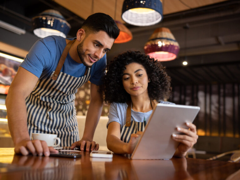 Business owners looking at a tablet.