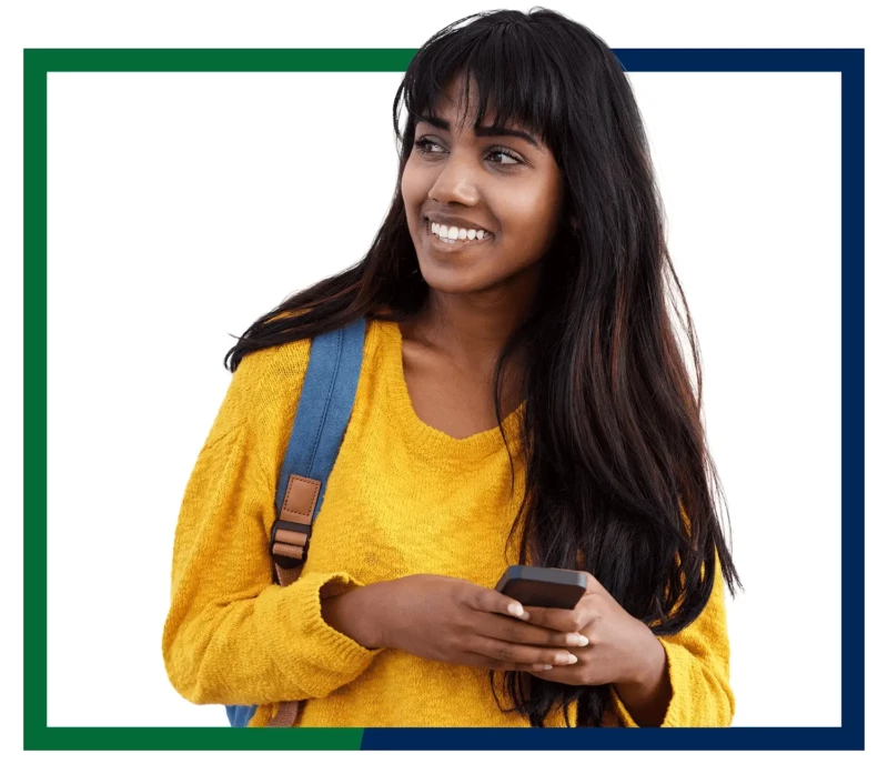 Young woman in yellow sweater, with a backpack and a cell phone.