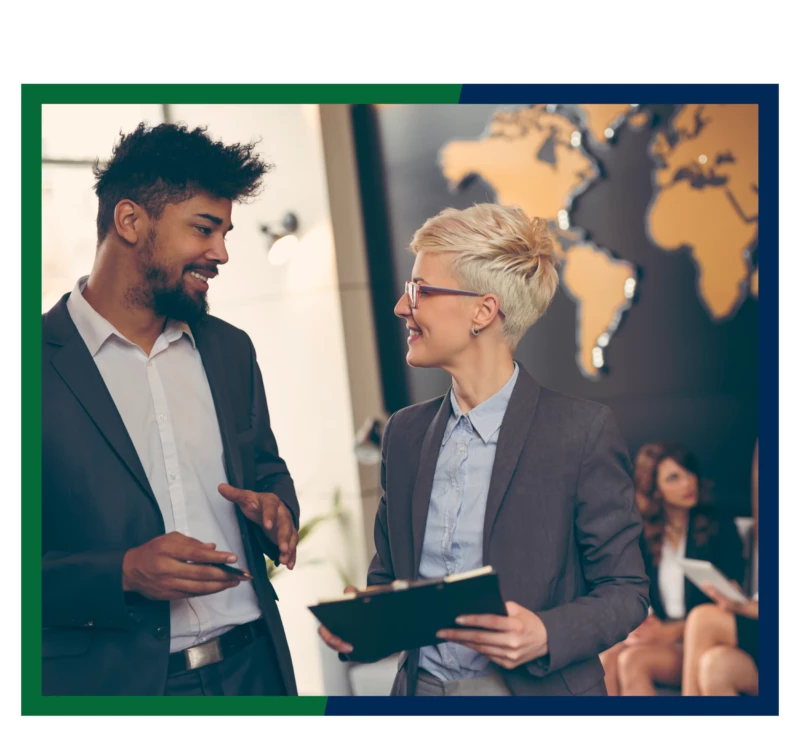 Businesspeople in front of a wall map.