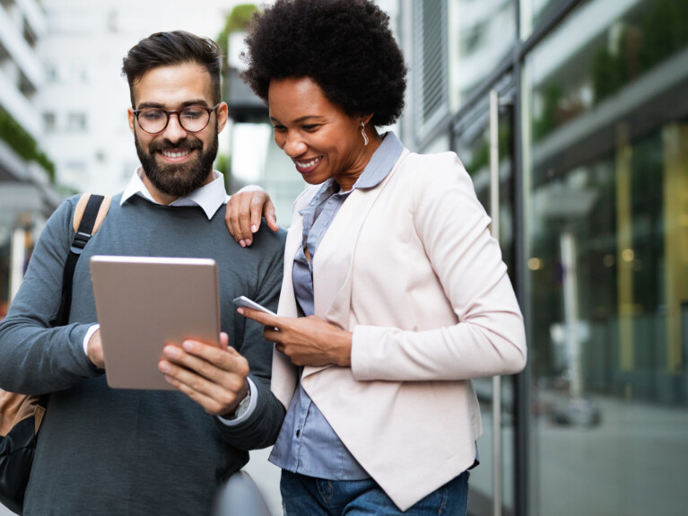 Two businesspeople using a tablet.