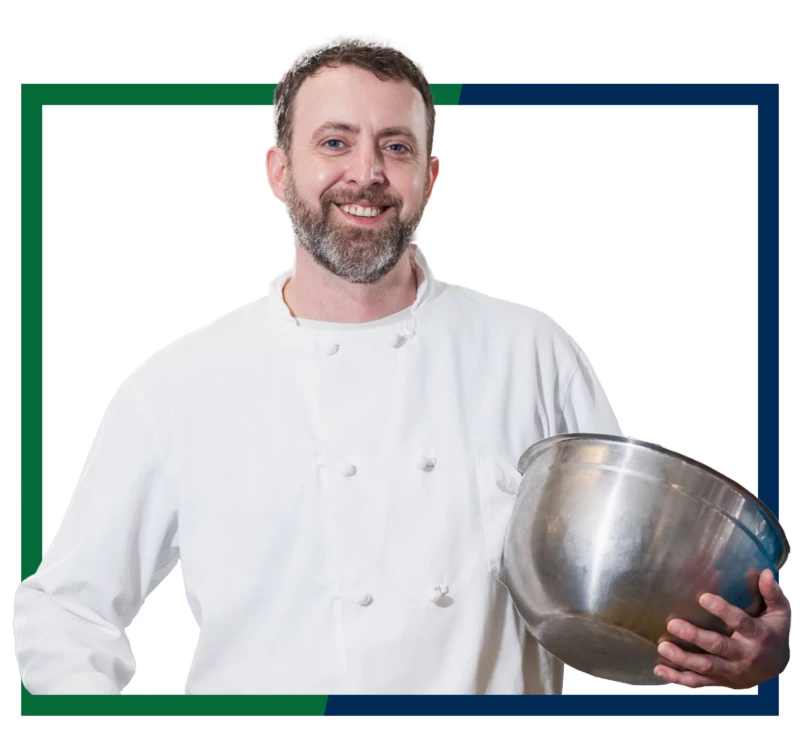 A chef holding a mixing bowl.