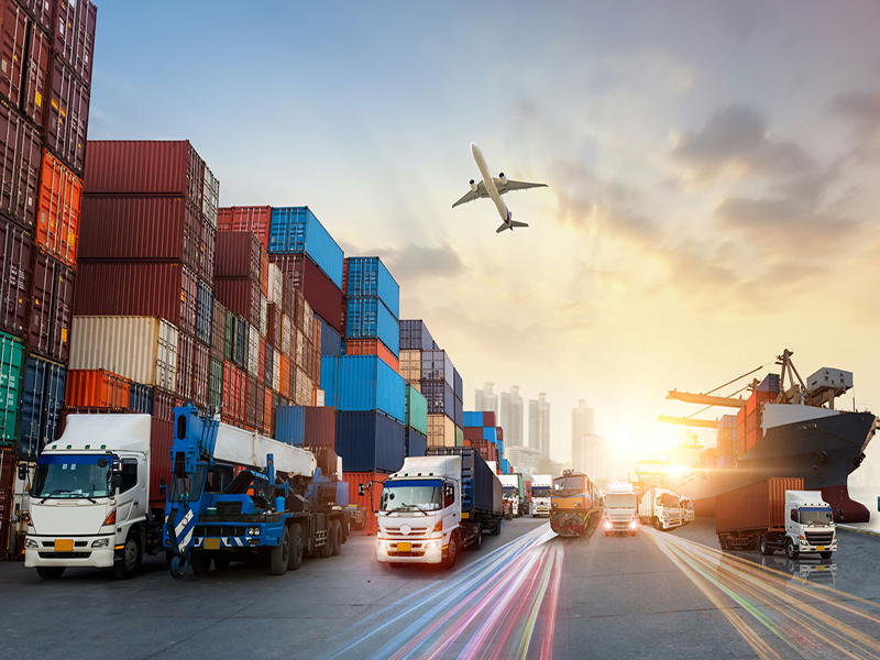 Commercial port with boat, shipping containers and plane overhead.