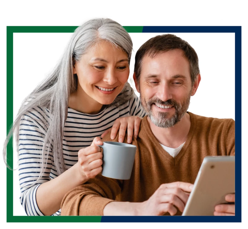 A man and woman using a tablet.