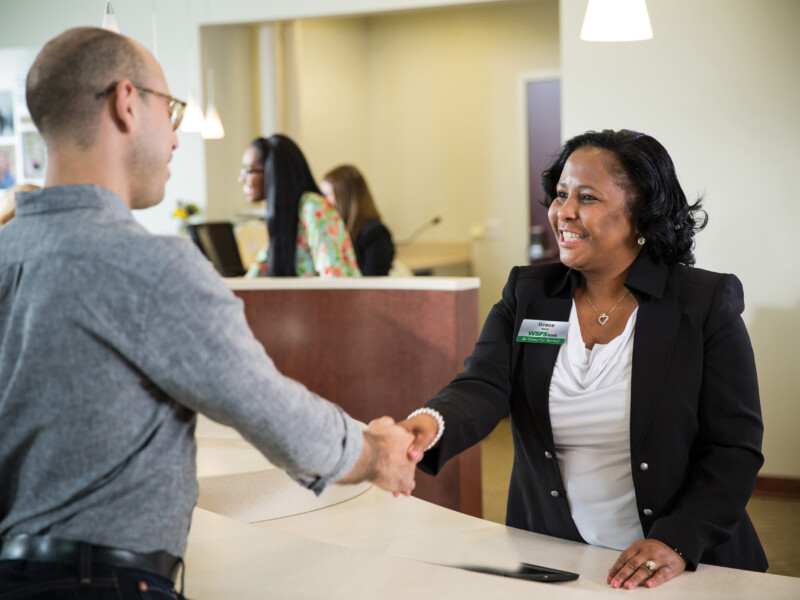 Grace, a WSFS Associate, shaking hands with a customer.