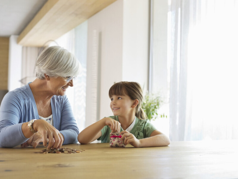 Grandmother and granddaughter sorting coins.