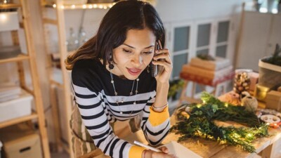 A woman using a cell phone.